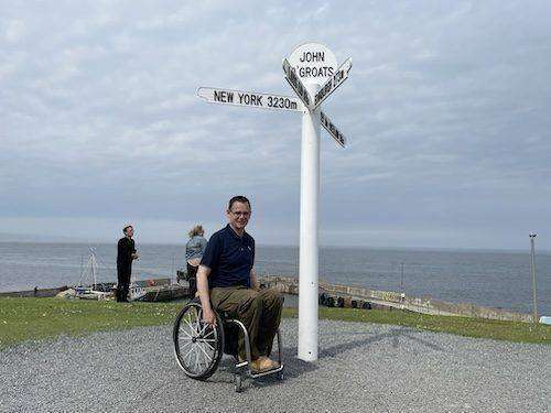 Paul visits John O'Groats and wheels up to the famous white signpost, with the wild sea as a backdrop.